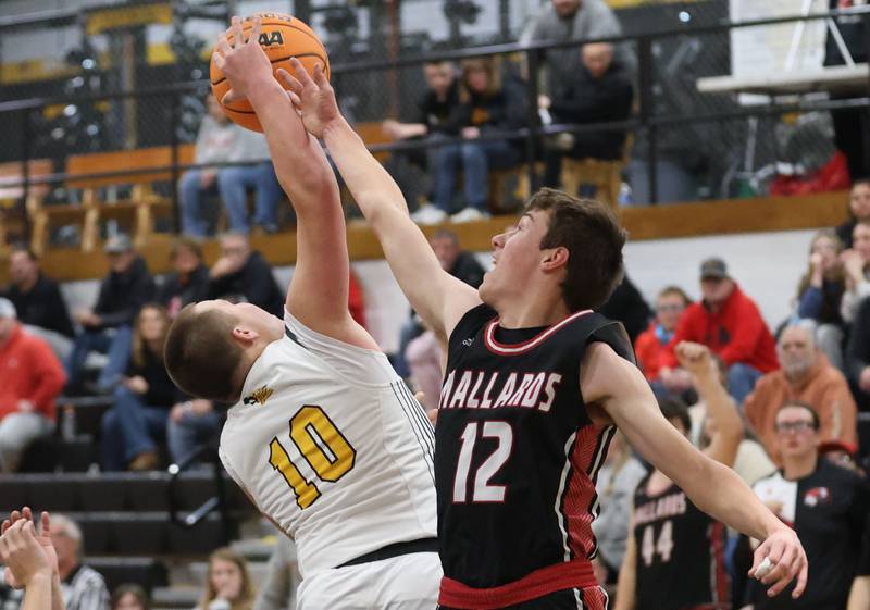Purnam County's Traxton Mattingly grabs a rebound over Henry-Senachwine's Ben Meachum on Friday, Dec. 5, 2025 at Putnam County High School.