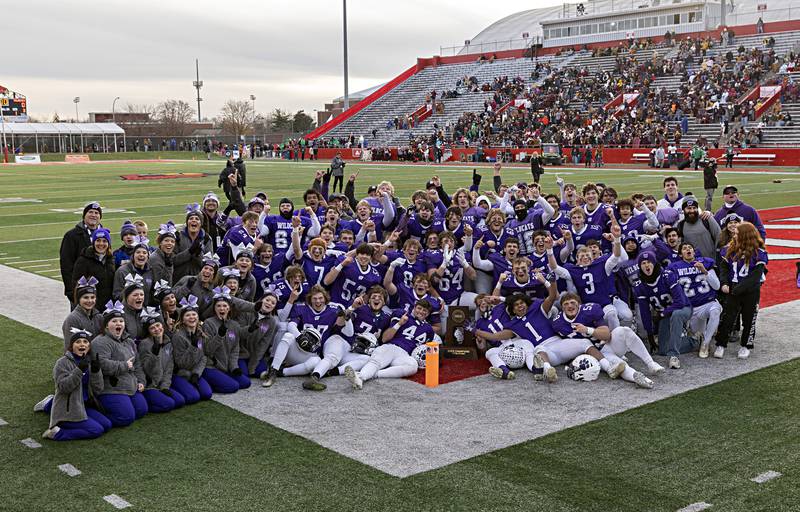 The Wilmington Wildcats celebrate their 28-3 win over Athens Friday, Nov. 24, 2023 in the 2A state football championship game at Hancock Stadium in Normal.