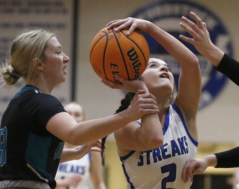 Woodstock's Brooklyn Kentgen is founded by Woodstock North's Makayla Nordahl as Kentgen drive to the basket during a Kishwaukee River Conference basketball game on Friday, Jan. 10, 2025, at Woodstock High School.