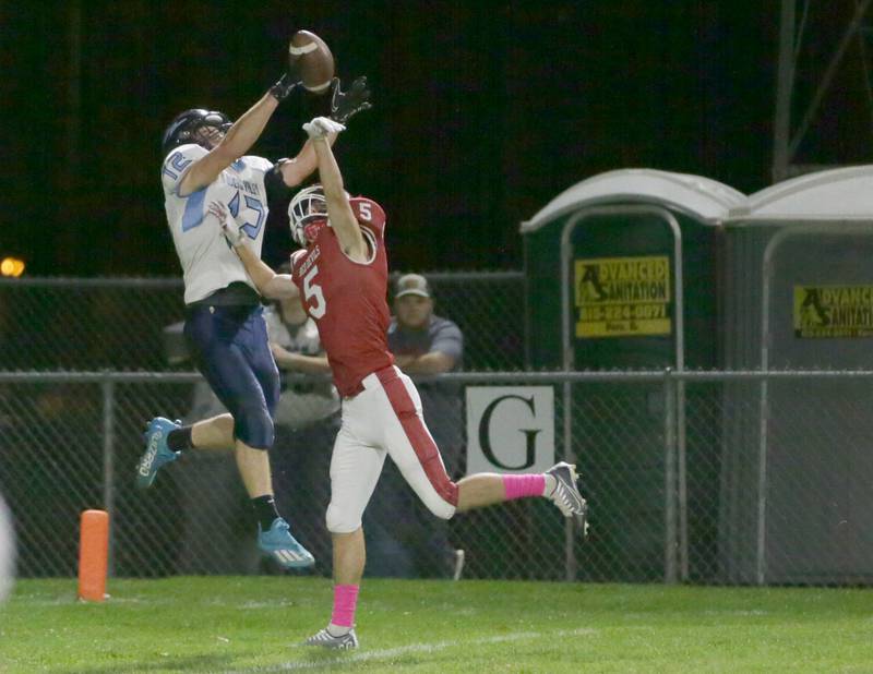 Bureau Valley's Issav Attig (12) makes a leaping catch over Hall's Joseph Bacidore (5) in the first quarter on Friday, Oct. 21, 2022 at Richard Nesti Stadium in Spring Valley.