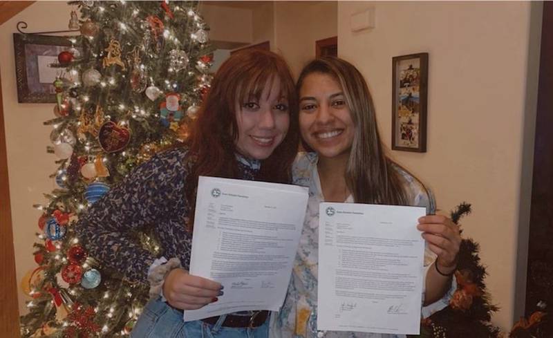 Jacobs senior Ana Lohman-Meza (left) and her sister Paty hold their letters confirming they received Chick Evans Scholarships from the Western Golf Association. Paty, a senior at Northwestern, received hers in 2017. Ana recently received hers.