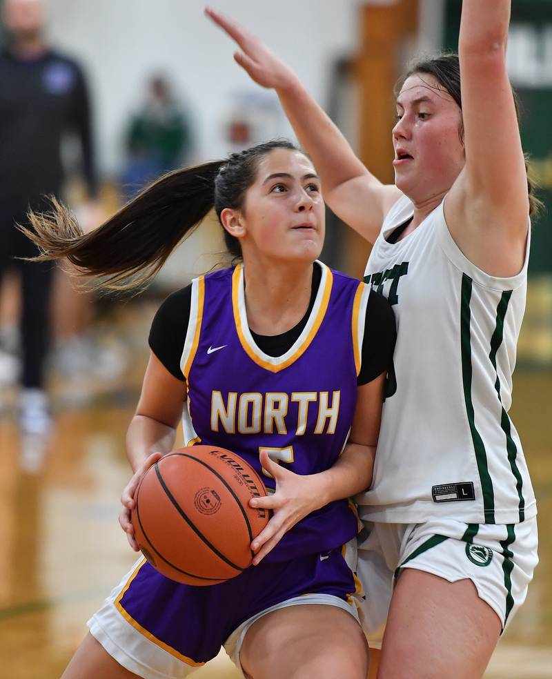 Downers Grove North's Campbell Thulin goes to the basket as Glenbard West's Glenbard West's Makenna Yeager defends during a game on Dec. 5, 2023 at Glenbard West High School in Glen Ellyn.