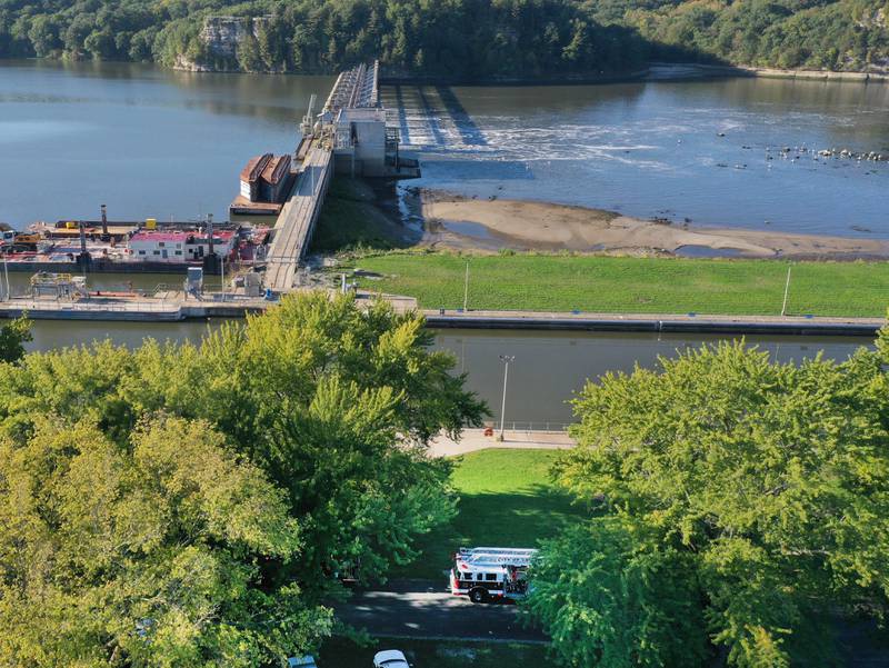 A Peru fire truck (bottom) can be seen as fire crews fight a fire inside the Starved Rock hydroelectric power plant at the Starved Rock Lock and Dam on Tuesday, Oct. 3, 2023 near Utica. A MABAS box alarm was sent out just before 730a.m. for a working fire inside the plant.
