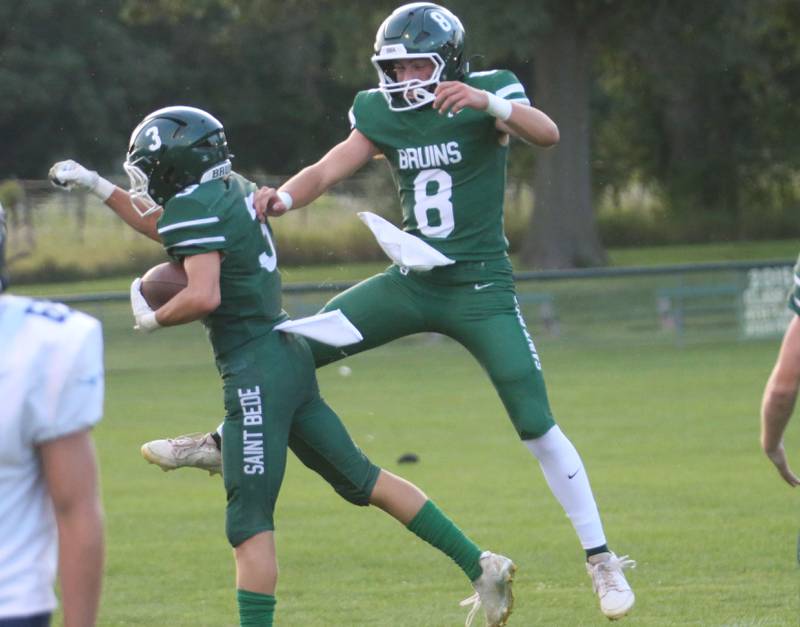 St. Bede's Stuart McGunnigal celebrates with quarterback Gino Ferrari after scoring a touchdown against Bureau Valley on Friday Aug. 29, 2025 at St. Bede Academy.