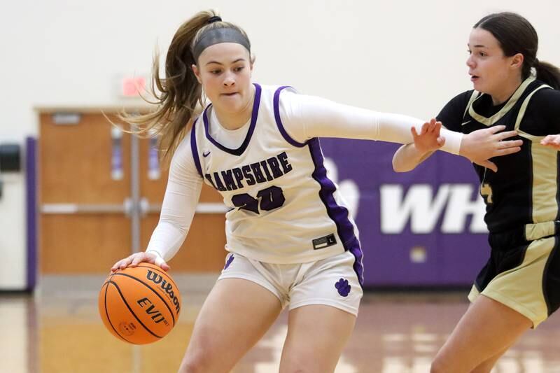 Hampshire’s Chloe Van Horn drives on Sycamore’s Layla Janisch in varsity girls basketball on Friday, Jan. 3, 2025, at Hampshire High School in Hampshire.