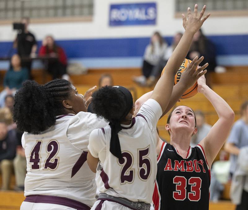 Amboy’s Bella Yanos works below the basket against Morgan Park Academy’s Logan Lomax (right) and Madison Olimene Tuesday, Feb. 25, 2025, in the Class 1A Sectional semifinal at Hinckley-Big Rock.