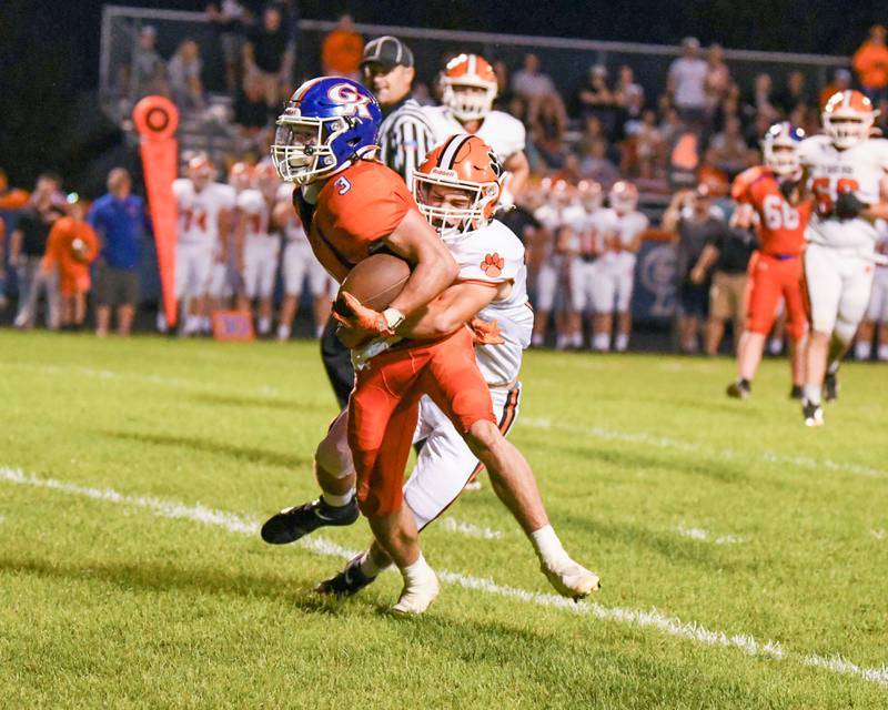 Genoa-Kingston Brody Engel (3) runs the ball before being tackled by Byron Kye Aken in the second quarter by Byron players at home at Geno-Kingston on Friday Sep 16th.