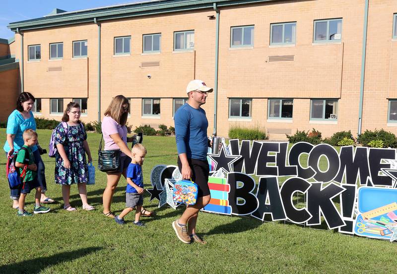 (Left to right) Karen Bobbe, kindergartner Thomas Ireland, fifth grader Laura Bobbe, Laura Ireland, preschooler Brooks Ireland and Shaun Ireland walk to Kaneland John Shields Elementary School on the first day of the 2023-34 school year in Sugar Grove on Wednesday, Aug. 16, 2023.