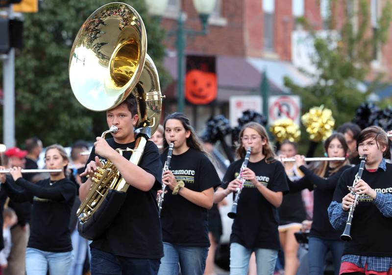 The Sycamore High School Marching Band plays its way down State Street Wednesday, Oct. 5, 2022, during the school's homecoming parade.