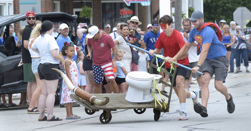 The Flush Gordon team loses control of their vehicle and driver during one of the heats during the annual Toilet Bowl Races as part of the towns 4th of July celebration.