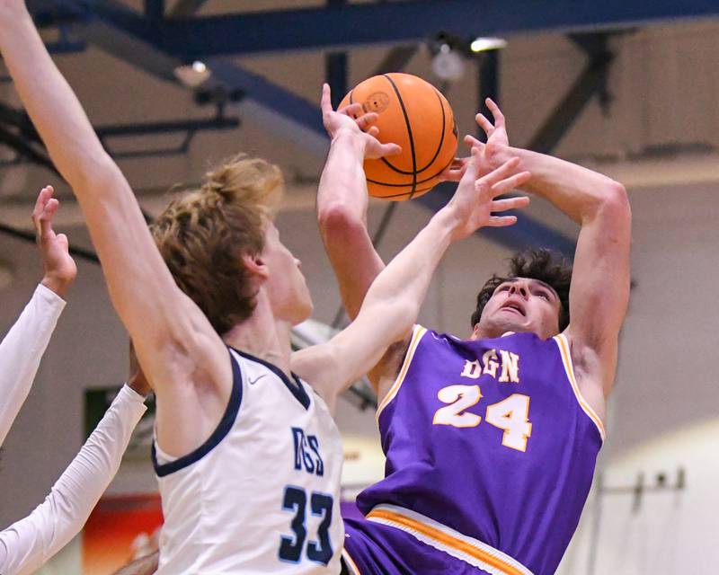 Downers Grove North's Aidan Akkawi (24) goes up for a shot while being defended by Downers Grove South's Erik Vagonis (33) during the game on Saturday Dec. 21, 2024, held at Downers Grove South High School.