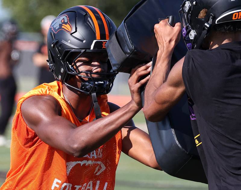 DeKalb’s Derrion Straughter works on taking on a blocker Monday, Aug. 11, 2025, during their first fall practice at the school.