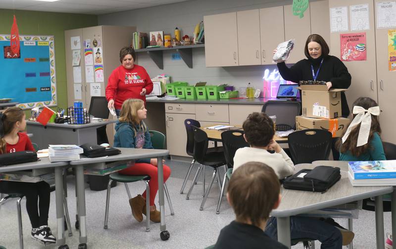 Mrs. Jennifer Ring and Mrs. Kearsten Zielinski open gifts donated to the school through the Small School Big Hearts campaign on Tuesday, Dec. 2, 2025 at Dimmick School in La Salle. The “Small School, Big Hearts” campaign is a toy drive organizded by third graders and celebrates the power of kindness, generosity and community spirit. Gifts will be wrapped and sent to Officer Santa with the La Salle Police Department and St. Jude. The school is accepting donations through Dec. 12.