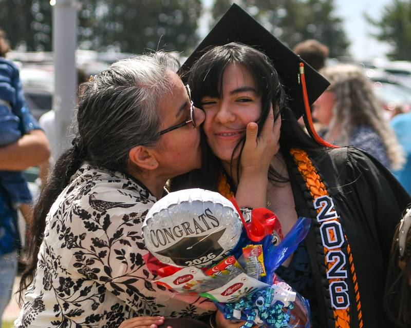 Maria Marquez kisses her daughter Emely Marquez Nunez after Emely received her diploma from DeKalb High School on Saturday May 23, 2026, held at the Convocation Center in DeKalb.