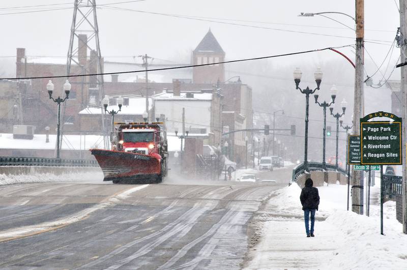 A snowplow crosses the Peoria Avenue Bridge Thursday afternoon, clearing the way for travelers during another snow storm in the Sauk Valley.