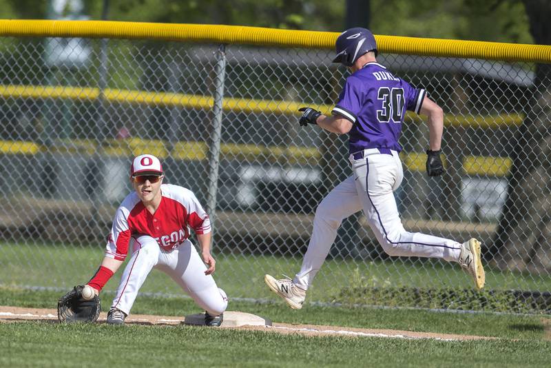 Oregon’s Jackson Werren digs a throw to get out a hustling Eli Dever of Dixon.