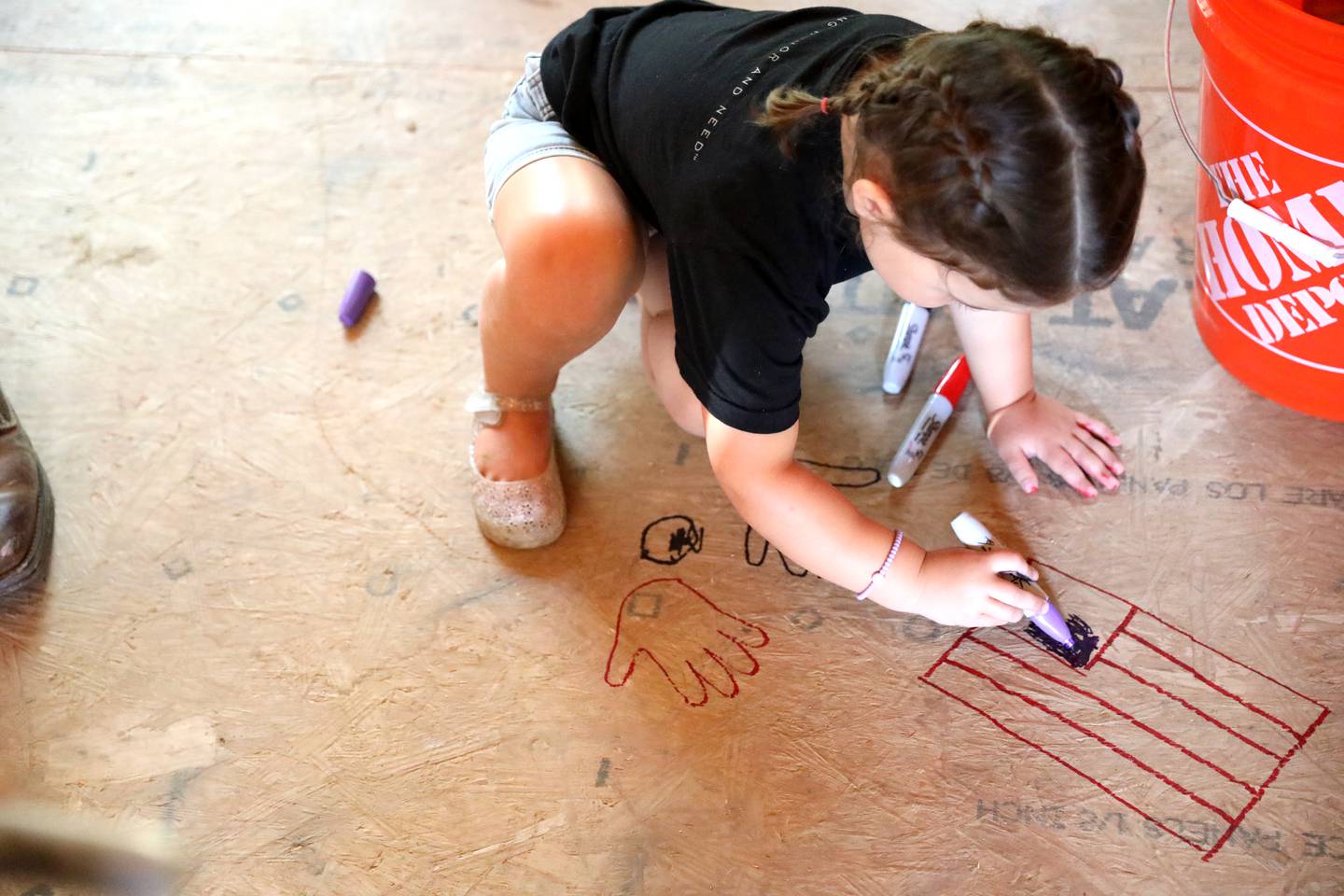 Gwendolyn Reynders, 4, whose father, Travis, is the project coordinator for the Gary Sinise Foundation, draws an American flag on the floor inside the under-construction home of Retired U.S. Army Chief Warrant Officer 2 Patrick Scrogin, who was critically wounded in a helicopter crash while deployed in Iraq in March 2007. The Gary Sinise Foundation’s R.I.S.E. (Restoring Independence, Supporting Empowerment) Program is building the home along with in-kind donations from various national partners, sub-contractors, and the American public.