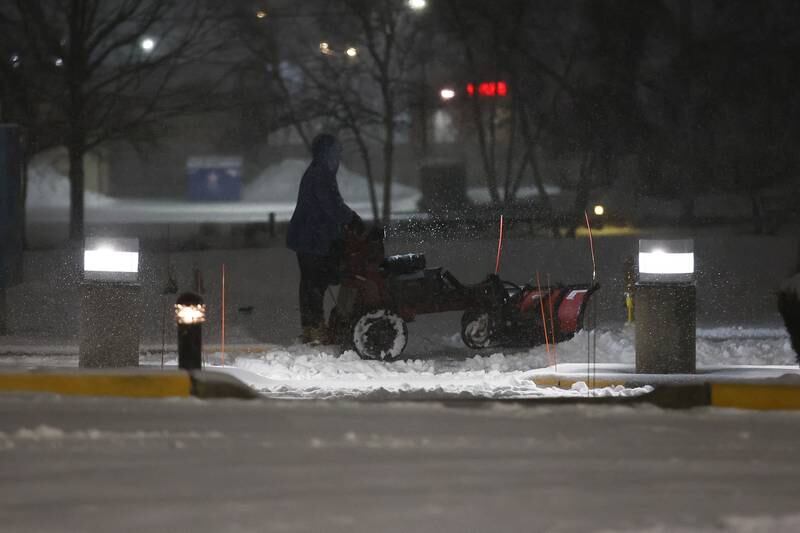 A snow clearing company works through the night to clear snow at AMITA Health St. Joseph Medical Center Joliet. Wednesday, Feb. 2, 2022 in Joliet.