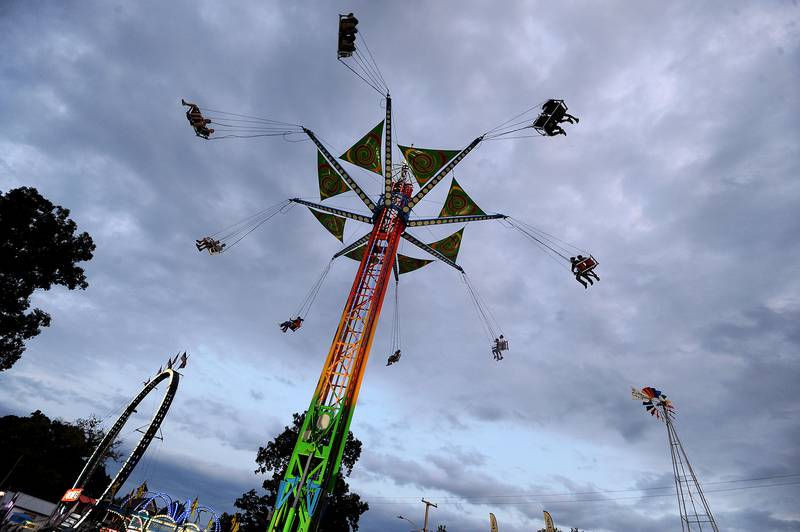 Riders soar through the evening sky at the Sandwich Fair on the Vertigo ride on Thursday, Sept. 5, 2024, at the fairgrounds in Sandwich.