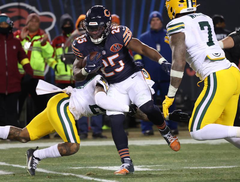 Chicago Bears running back Kyle Monangai breaks through the Green Bay Packers defensive line Saturday, December 20, 2025, during their game at Soldier Field in Chicago.