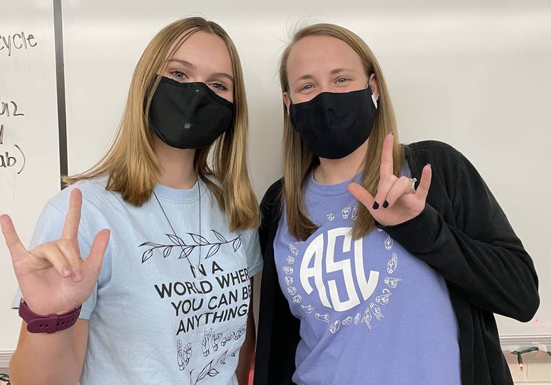 Plainfield East High School senior and American Sign Language Club President Brooke Scott (left) poses for a picture with PEHS ASL teacher and club sponsor Cortney Troy. Scott and the club raised $675 for SignUp, a new app helps deaf and hard of hearing children watch movies.