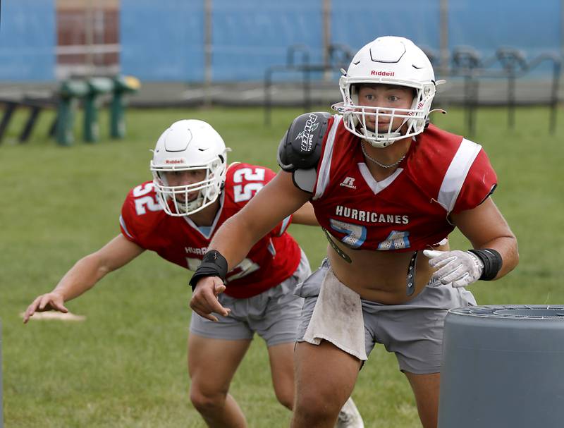 Marian Central’s Matt Conlon, (right) and Dan French rush the passer during football practice on Tuesday, August 19, 2025, at Marian Central  High School in Woodstock.