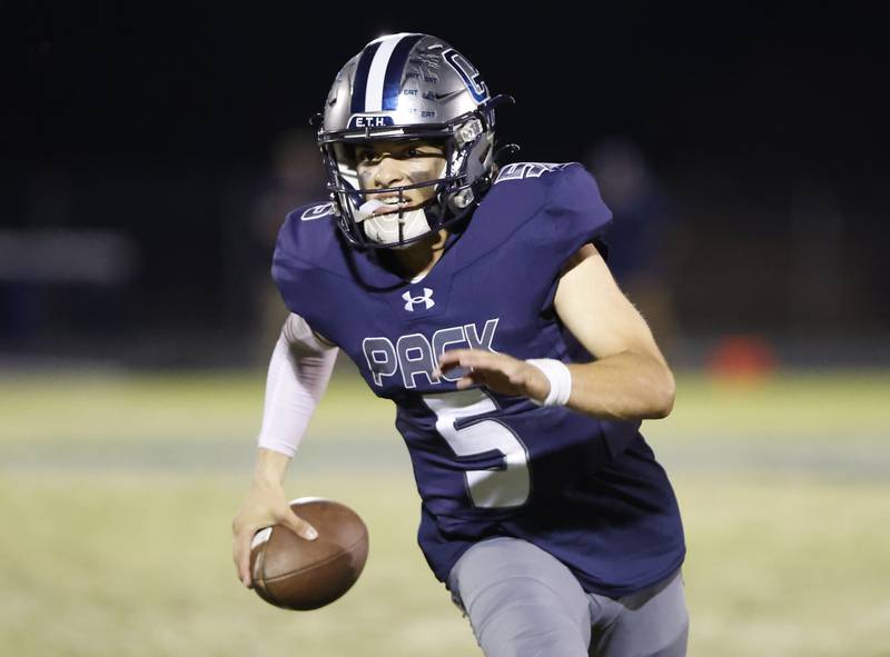 Oswego East's Niko Villacci (5) scrambles during the varsity football game between Plainfield South and Oswego East on Friday, Sep. 20, 2024 in Oswego.
