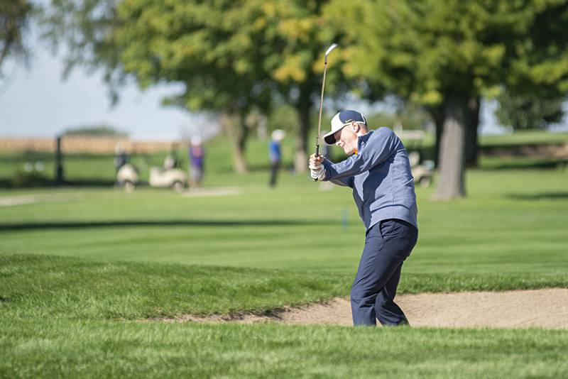 Sterling’s Cameron O’Brien hits out of the trap on no.10 at Emerald Hill in Sterling for the Class AA IHSA sectional golf meet.