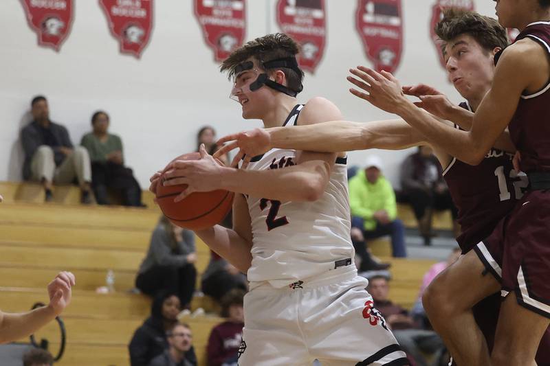 Lincoln-Way Central’s Will Gehrke pulls in a rebound against Lockport on Tuesday, Jan. 23rd, 2024 in New Lenox.