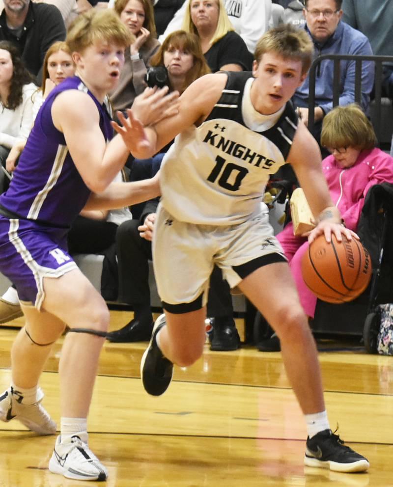 Kaneland’s Troyer Carlson dribbles around Rochelle’s Carson Lewis during their game on Friday, Feb. 9, 2024 in Rochelle.