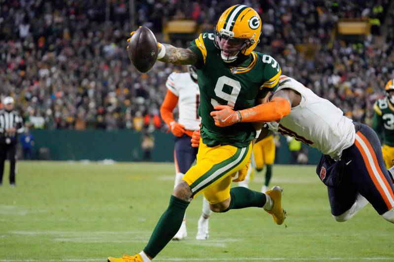 Green Bay Packers wide receiver Christian Watson (9) runs to score a touchdown against Chicago Bears safety Kevin Byard III (31) during the first half of an NFL football game Sunday, Dec. 7, 2025, in Green Bay, Wis. (AP Photo/Morry Gash)