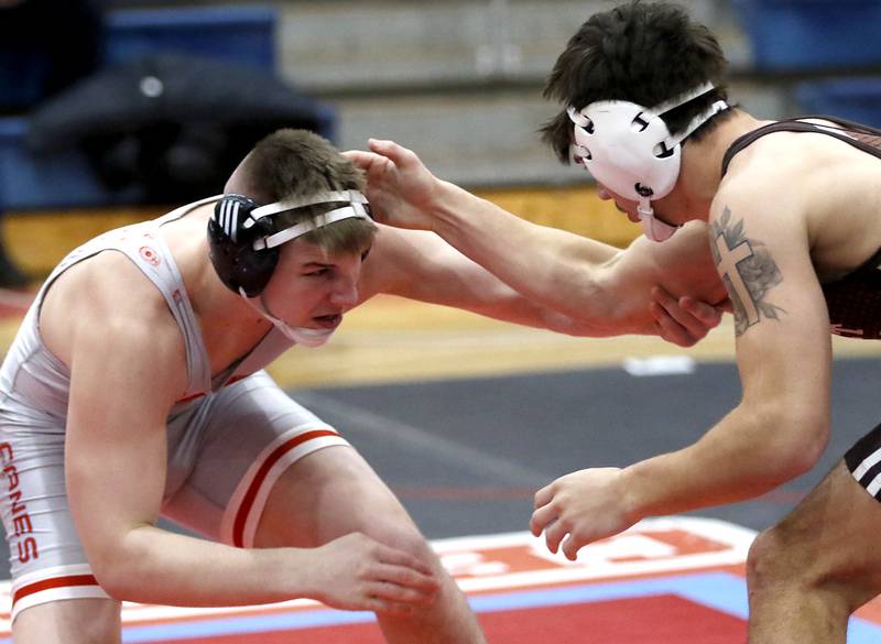 Marian Central's Jimmy Mastny tries to fend off Joliet Catholic's Issac Clauson in their 190-pound match during a triangle wrestling meet on Saturday Jan. 11, 2025, between Marian Central, Joliet Catholic, and Mt. Carmel at Marian Central High School in Woodstock.