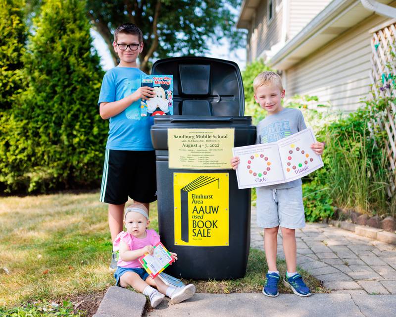 Mikey and Henry Ehmann and Hailey Klenck donate books as they look forward to the Elmhurst AAUW Used Book Sale August 4-7 at Sandburg Middle School in Elmhurst.