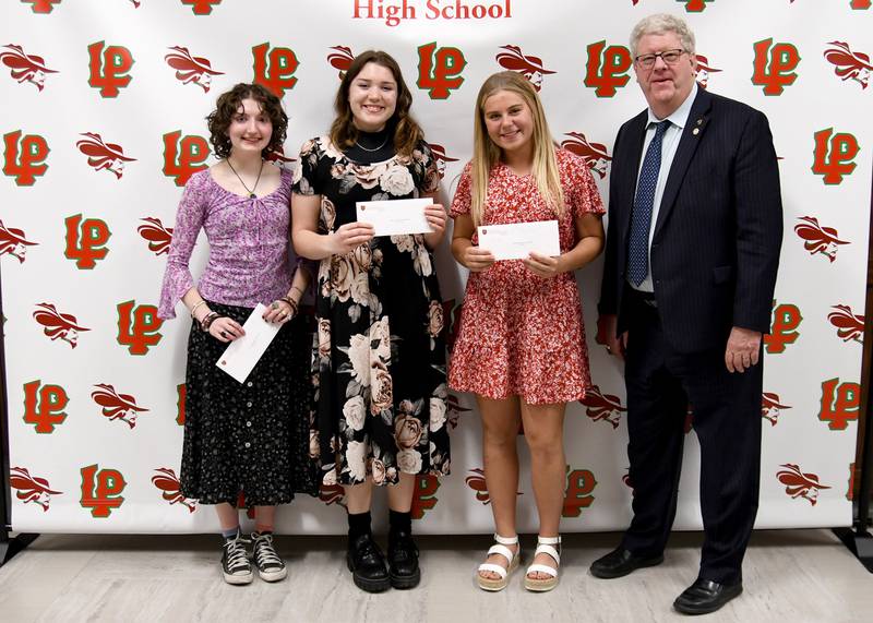 La Salle-Peru High School seniors (from left) Katie Keating, Jordyn McCoy and Ava Lannen received the Robert Alpert Memorial Scholarship, presented by J. Burt of Heartland Bank. The scholarship was established in memory of Robert Alpert, who was a beloved educator, counselor, and coach at Peru Washington School.
