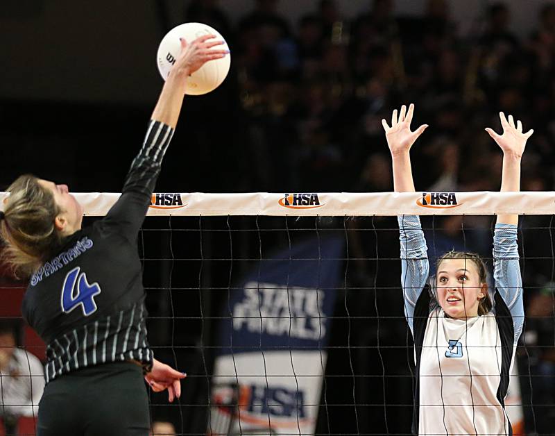 St. Francis's Brooke Everett (4) sends a kill past Joliet Catholic's Dalani Kirstein (5) in the Class 3A semifinal game on Friday, Nov. 11, 2022 at Redbird Arena in Normal.