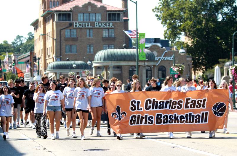 The St. Charles East High School girls basketball team marches in the school’s annual homecoming parade on Friday, Sept. 13, 2024 on Main Street in St. Charles.