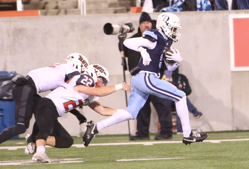DePaul's Braden Peevy sprints down the sideline to score a touchdown and escape a tackle from Mt. Zion's Jacob Harvy and Jonny Jordan during the Class 4A State football championship on Friday, Nov. 29, 2024 at Hancock Stadium in Normal.