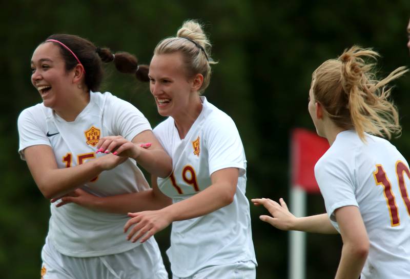 Richmond-Burton’s Layne Frericks, center, celebrates with Brianna Maldonado, left, and Margaret Slove, right, after Frericks scored a second-half goal against DePaul Prep during sectional title game action at Marian Central in Woodstock Friday evening.