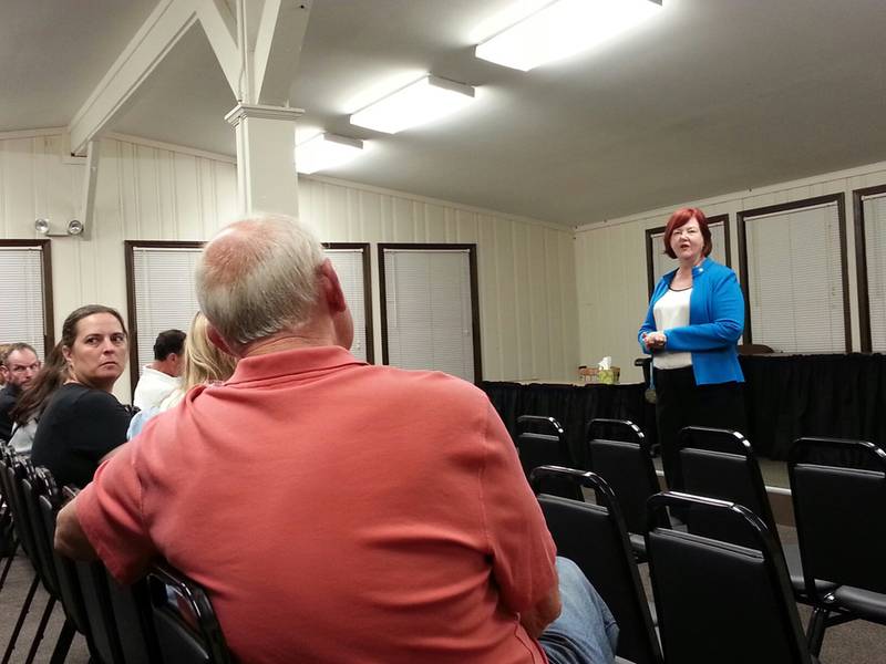 State Rep. Margo McDermed, R-Mokena, (front) speaks with a Lincoln-Way resident at a town hall meeting Monday.