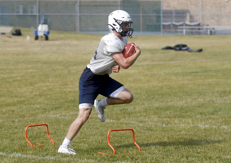 Cary-Grove’s Jack Rocen runs a drill during football practice Thursday, June 29, 2023, at Cary-Grove High School in Cary.