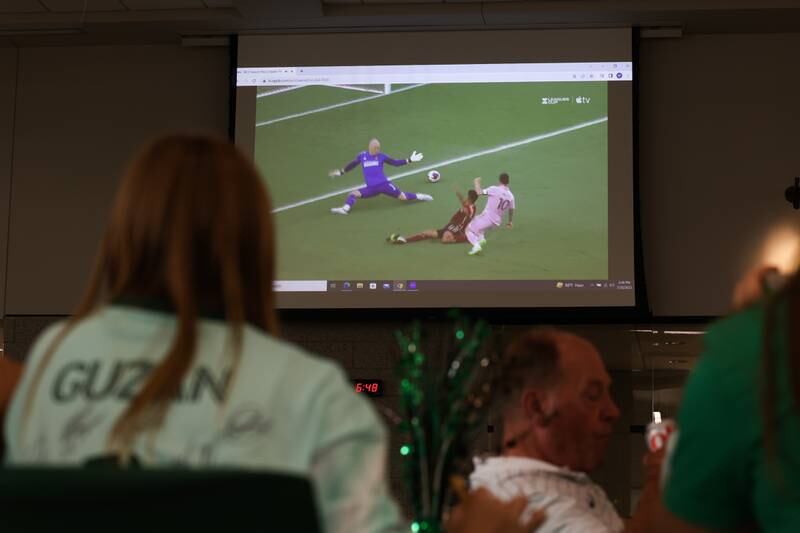 A fan watches as Atlanta’s Brad Guzan stretches for a shot by Miami’s Messi at the Providence Catholic Brad Guzan watch party on Tuesday, July 25 in New Lenox. Guzan is a Providence Catholic alumnus who plays goalie for MLS’ Atlanta United FC.
