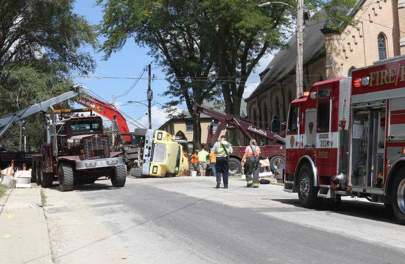 Peru Fire Department arrives on the scene as a cement truck is lifted out of a sinkhole on Tuesday, Sept. 2, 2025 at the intersection of Pulaski Street and 6th Streets in Peru.