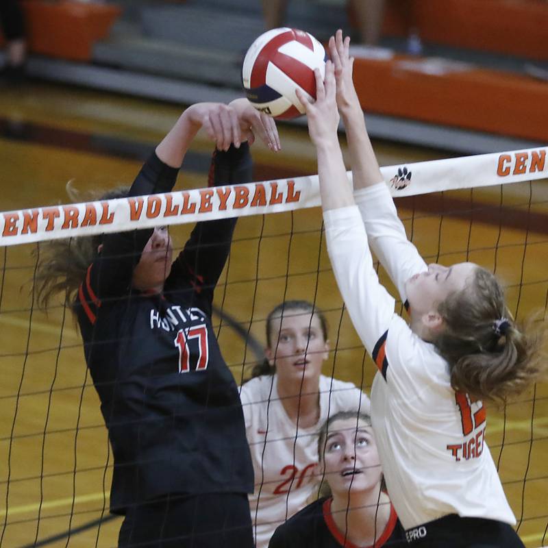 Huntley’s Georgia Watson tries to hit the ball through the block of Crystal Lake Central’s Gabbie Anderson during a Fox Valley Conference volleyball match Tuesday, Aug. 23, 2022, between Crystal Lake Central and Huntley at Crystal Lake Central High School.