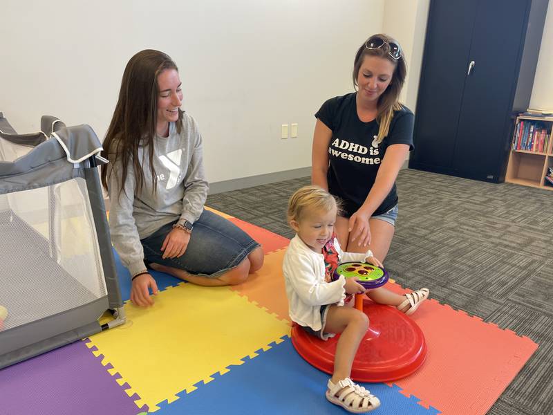 Illinois Valley Community College student Kristina McConnaughhay, of La Salle, (right), and daughter Everly with YMCA child watch staff member Laura Thurow of Mendota. The center opened this week at IVCC. The college announced all students can take a late-start or second eight-week class tuition-free.