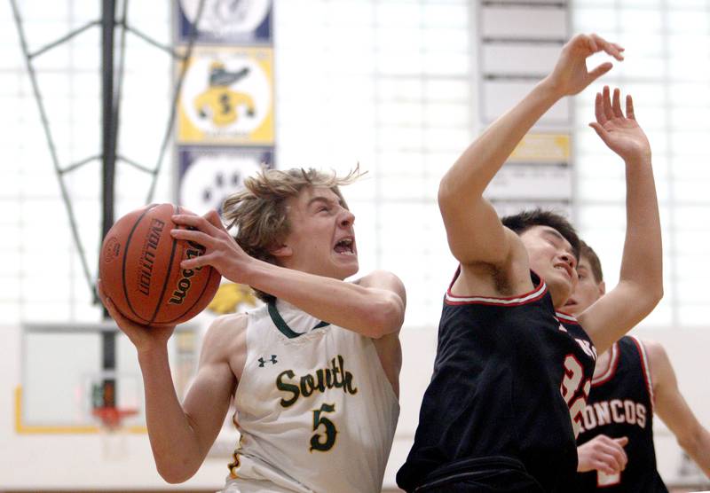 Crystal Lake South’s Carson Trivellini, left, moves to the hoop against Barrington’s Bruce LeBlanc in Hinkle Holiday Classic boys basketball tournament game action at Jacobs High School Tuesday.