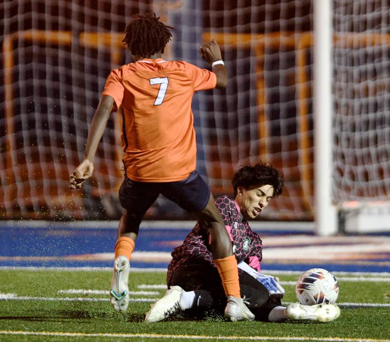 York goalkeeper Diego Ochoa makes a save as Romeoville’s Christian Agyekum charges toward the net in the Class 3A semifinal game of the boys state soccer tournament in Hoffman Estates on Friday, November, 4, 2022.