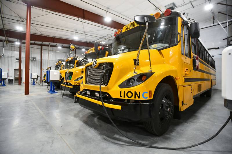 Electric buses charges in the new garage at Herscher High School in October during the opening event of the district's maintenance garage. The Herscher School District implemented 25 new electric buses this year through a U.S. Environmental Protection Agency grant of nearly $10 million.