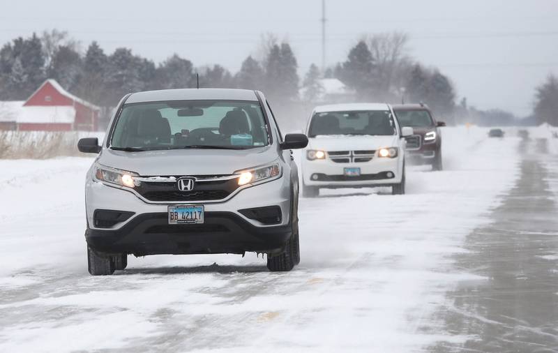 Vehicles carefully make their way down Route 23 near DeKalb Wednesday, Feb. 2, 2022, as blowing and drifting snow covers the pavement. Snow overnight and into Wednesday made travel hazardous in parts of DeKalb County.