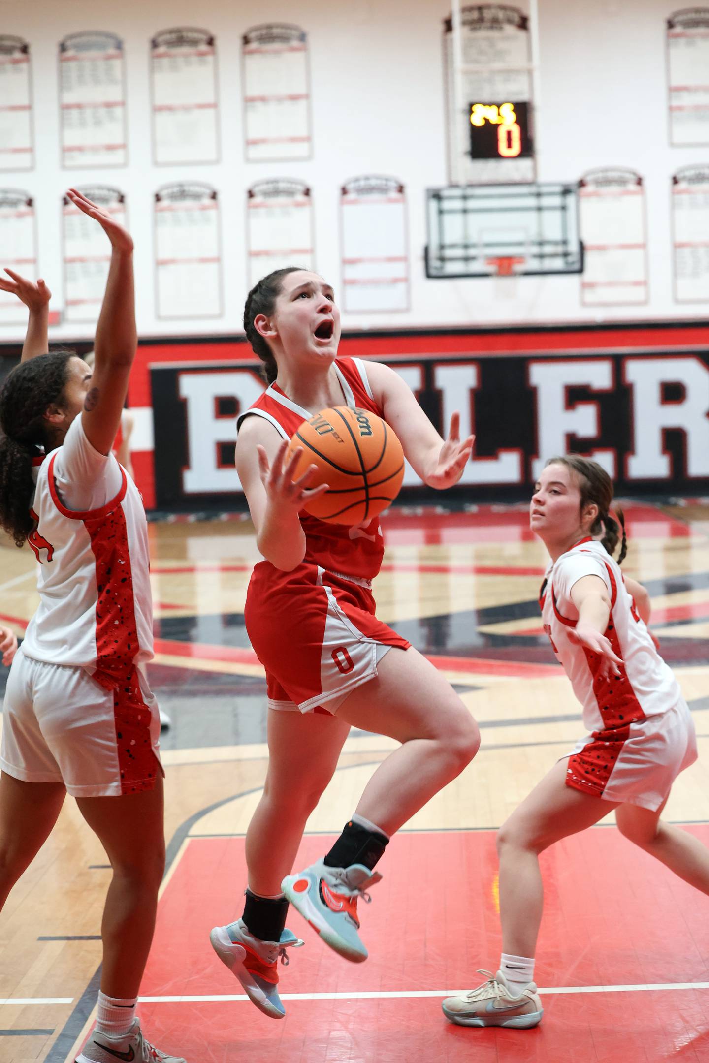 Ottawa's Mary Stisser maneuvers to the hoop against Bradley-Bourbonnais' Nia Lawrence, left, and Katie McBurnie during Ottawa's 55-44 victory on Monday, Feb. 9, 2026.