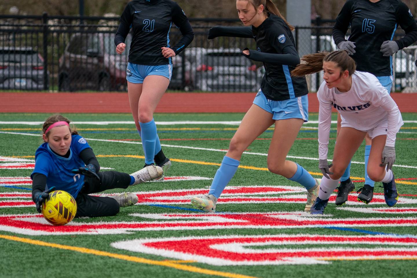 St. Charles North's Kara Claussner (0) makes a diving save against a shot by Oswego East's Ashley Gumm (18) during a Naperville Invitational soccer match at Naperville Central High School on Saturday, April 22, 2023.
